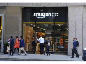 FILE - In this Jan. 30, 2019, file photo people walk past and into an Amazon Go store in San Francisco. An Amazon Go store opening Tuesday, May 7, 2019, in New York, will be the first of its kind to accept cash.