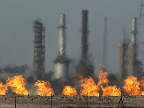 Fires flare off the gas from crude oil at an Iraq oil processing plant. WTI prices were down US$3.04, or 5 per cent, at US$58.39 Thursday morning.