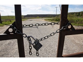 In this April 8, 2019, photo, the entrance to the coal-waste dump site is padlocked in Bokoshe, Okla. President Donald Trump's EPA has approved Oklahoma to be the first state to take over permitting and enforcement on coal-ash sites.