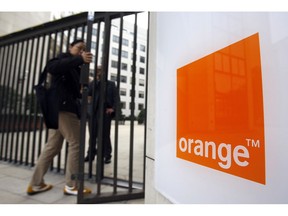 FILE - In this Oct.29, 2009 file photo, people enter the headquarters of France Telecom SA in Paris. French telecom giant Orange and seven former or current managers are going on trial Monday May 6, 2019, accused of moral harassment over a wave of employee suicides a decade ago.