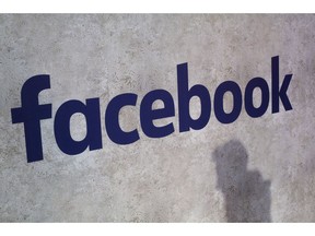 FILE - This Jan. 17, 2017, file photo shows a Facebook logo displayed in a start-up companies gathering at Paris' Station F in Paris. Facebook CEO Mark Zuckerberg will meet Friday May 10, 2019 French President Emmanuel Macron as the tech giant and France try to pioneer ways of fighting hate speech and violent extremism online.