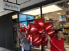 People walk out of a Party City store with balloons on in Miami, Florida. Party City announced that it will shutter 45 stores in 2019 due to a global helium shortage.