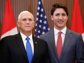 U.S. Vice President Mike Pence and Prime Minister Justin Trudeau stand for a photograph at Parliament Hill in Ottawa on Thursday.