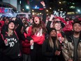 In this Sunday, May 12, 2019, file photo, basketball fans cheer for the Toronto Raptors before claiming victory over the Philadelphia 76ers outside Maple Leaf Square during the second half of an NBA Eastern Conference semifinal basketball game in Toronto.