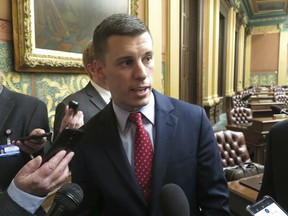 Michigan House Speaker Lee Chatfield, R-Levering, speaks with reporters following the House's approval of a bill that would cut auto insurance premiums on Thursday, May 9, 2019, in the Capitol in Lansing, Mich. Democratic Gov. Gretchen Whitmer threatened to veto the legislation if it gets to her desk without changes.