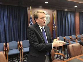 Sen. Aric Nesbitt, a Lawton Republican, speaks with reporters following a Senate committee's party-line vote in favor of his bill that would end a requirement that drivers have unlimited medical coverage through their car insurer on Tuesday, May 7, 2019, in Lansing, Mich. Nesbitt says health costs are driving high auto insurance rates in the state.
