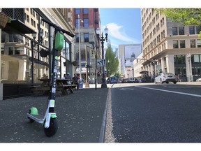 A Lime e-scooter sits parked on a street in downtown Portland, Ore., Thursday, May 9, 2019. A disability rights nonprofit group in Oregon filed a letter of complaint Thursday with the city of Portland over new rules about an electric scooter pilot program.