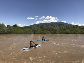 In this May 4, 2019, photo two kayakers float the Rio Grande through Corrales, New Mexico. Rafting and angler guides are predicting a good season for tourism along the river thanks to strong runoff generated by a healthy snowmelt this year.