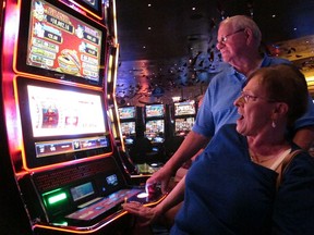 In this June 25, 2018 photo, Joyce Green of Vineland, N.J. reacts to a winning spin at a slot machine as her husband Tom looks on inside the Ocean Casino Resort in Atlantic City, N.J. The casino formerly known as Revel will turn a profit in May after months of steep losses.