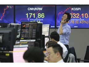 A currency trader talks on the phone at the foreign exchange dealing room of the KEB Hana Bank headquarters in Seoul, South Korea, Thursday, May 30, 2019. Asian shares were mostly lower Thursday after another round of selling on Wall Street and investor worries about a trade war.