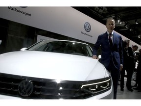 Herbert Diess, CEO of the Volkswagen stock company, poses next to a Volkswagen car prior to the company's annual general meeting in Berlin, Germany, Tuesday, May 14, 2019.