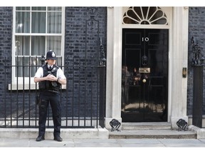 A police officer stands outside 10 Downing Street, the residence of British Prime Minister Theresa May, in London, England, Friday, May 24, 2019. Conservative lawmakers have given May until Friday to announce a departure date or face a likely leadership challenge.