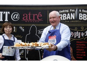 U.S. Secretary of Agriculture Sonny Perdue serves sandwiches with American meat in Tokyo Monday, May 13, 2019. Perdue barbecued American beef in Tokyo to highlight his message: Japan must treat the U.S. fairly as a top customer for Japanese products.