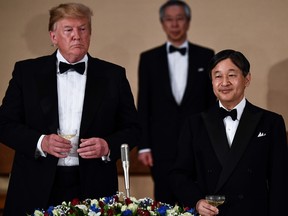 US President Donald Trump, left, and Japan's Emperor Naruhito attend a state banquet at the Imperial Palace in Tokyo on Monday.