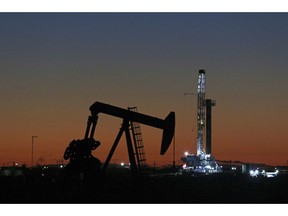 FILE - This Oct. 9, 2018, file photo shows an oil rig and pump jack in Midland, Texas. The Environmental Integrity Project noted in a report released Thursday, May 9, 2019, that the Permian Basin, which include some West Texas cities, such as Midland, is one of the most productive hydrocarbon regions in the world. But the report says a consequence of that production is dangerous levels of sulfur dioxide escaping into the air around Odessa and other locations.