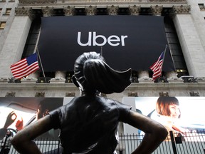 The statue of Defiant Girl stands in front of the New York Stock Exchange where Uber, the world's largest ride-hailing service, holds its initial public offering today.