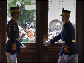 German Chancellor Angela Merkel, center, waits for a door to be opened as she arrives for an EU summit in Sibiu, Romania, Thursday, May 9, 2019. European Union leaders on Thursday start to set out a course for increased political cooperation in the wake of the impending departure of the United Kingdom from the bloc.