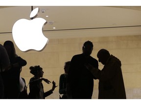 FILE- In this May 31, 2018, file photo customers enter the Apple store in New York. The Supreme Court is allowing consumers to pursue an antitrust lawsuit that claims Apple has unfairly monopolized the market for the sale of iPhone apps.
