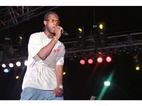 FILE - In this April 12, 1997, file photo, Prakazrel "Pras" Michel, part of the group the Fugees, sings on stage during a concert in Port-au-Prince, Haiti. A lawyer for one of the founding members of the 1990s hip hop group the Fugees says his client is facing charges related to 2012 campaign contributions. Defense lawyer Barry Pollack said Friday, May 10, 2019, that Michel is innocent and looks forward to having the case heard by a jury.