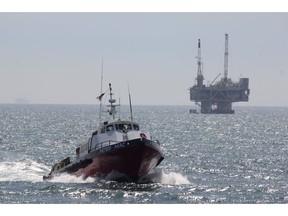 FILE - This May 16, 2015, file photo, shows a service boat carrying workers back to shore from a platform off Seal Beach, Calif. The Trump administration is easing safety rules adopted after the 2010 BP Deepwater Horizon blowout, the worst offshore oil disaster in U.S. history.