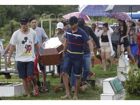 Relatives carry the coffin that contain the remains of 25-year-old William de Souza, an inmate who was killed in the recent prison riots, to a burial site in Manaus, Brazil, Thursday, May 30, 2019. Families were burying victims of several prison riots in which dozens of inmates died in the northern Brazilian state of Amazonas, as authorities confirmed they had received warnings of an "imminent confrontation" days before the attacks begun.