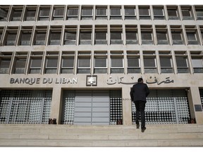 FILE - This Tuesday, Jan. 22, 2019 file photo, a man heads to the Lebanese central bank, in Beirut, Lebanon. The Beirut Stock Exchange said Monday, May 6, 2019, that it is suspending trading due to the open strike declared by the employees of Lebanon's central bank. Hundreds of Lebanese public employees are on strike amid concerns that their salaries and benefits might be cut as the government discusses an austerity budget.