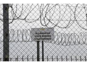 In this photo taken Monday, April 8, 2019, a sign reading: "State Border" is attached to a fence at Hungary's border with Serbia near the village Asotthalom, Hungary. With a campaign centered on stopping immigration, Hungary's ruling Fidesz party is expected to continue its dominance in the European Parliament election at the end of May. While Hungary has been practically closed to immigrants from the Middle East, Asia and Africa since Prime Minister Viktor Orban had border fences built in 2015, he continues to warn voters about the threat of a "migrant invasion" that would put at risk Europe's Christian culture.