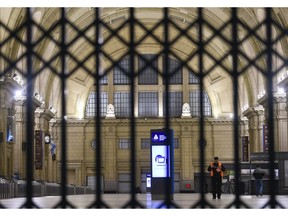 A policeman stands inside the Constitution railway station empty of commuters in Buenos Aires, Argentina, Wednesday, May 29, 2019, during a nationwide strike that shut down public transportation. Dozens of flights were canceled while banks, schools and the public administration closed their doors in the fifth national strike against austerity measures implemented by Maurico Macri's government.