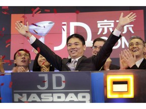 FILE - In this file photo taken May 22, 2014, Liu Qiangdong, also known as Richard Liu, CEO of JD.com, raises his arms to celebrate the IPO for his company at the Nasdaq MarketSite, in New York. Six Chinese social media accounts have been shut down after advocating support for a woman who has accused JD.com founder Richard Liu of rape.