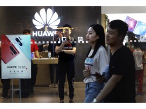 In this Monday, May 20, 2019, photo,  shoppers visit a Huawei store in Beijing. Chinese tech giant Huawei has filed a motion in U.S. court challenging the constitutionality of a law that limits its sales of telecom equipment.