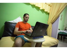 FILE - In this Jan. 6, 2017 photo Roberto Carlos Villamar uses his laptop on the new experimental internet in the living room of his home in Havana, Cuba. Cuba announced Wednesday, May 29, 2019 that it is legalizing private Wi-Fi networks and the importation of equipment like routers, eliminating one of the world's tightest restrictions on internet use.