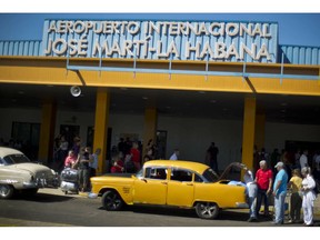 FILE - In this Sept. 1, 2014 file photo, people put their luggage in a private taxi as they arrive from the U.S. to the Jose Marti International Airport in Havana, Cuba. In 1958, the father of José Ramón López owned Cuba's main airport, its national airline and three small hotels. All were taken in Cuba's socialist revolution. Starting Thursday, they will be able to file lawsuits against European and American companies doing business on their former properties, thanks to the Trump administration's decision to activate a provision of the U.S. embargo on Cuba with the potential to affect foreign investment in Cuba for many years to come.