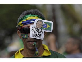 A man wears the Portuguese message: "Be strong Moro," referring to Brazil's Justice Minister Sergio Moro," during a pro-government rally on Copacabana beach in Rio de Janeiro, Brazil, Sunday, May 26, 2019. Moro recently saw Congress reject President Jair Bolsonaro's move to put him in charge of the country's financial regulator and is having trouble passing a sweeping "anti-crime" bill in Congress.