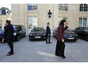 New Zealand Prime Minister Jacinda Ardern, right, leaves after a press conference, at the OECD headquarters, in Paris, Tuesday, May 14, 2019. The leaders of France and New Zealand will make a joint push to eliminate acts of violent extremism from being shown online, in a meeting with tech leaders in Paris on Wednesday.