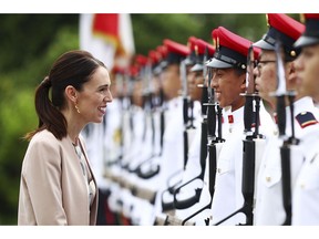 New Zealand's Prime Minister Jacinda Ardern speaks with a member of the honor guard during a welcome ceremony at the Istana or presidential palace in Singapore, Friday, May 17, 2019.