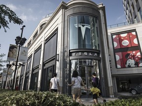 Pedestrians walk past a Tesla Inc. showroom in Shanghai, China. The country is Tesla's second-biggest market after the U.S.