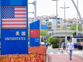 Signs with the U.S. flag and Chinese flag are seen at the Qingdao free trade port area in Qingdao in China's eastern Shandong province.