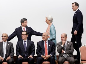 Yi Gang, governor of the People's Bank of China, back left; Christine Lagarde, managing director of the International Monetary Fund; and Bill Morneau, Canada's finance minister, at the Group of 20 finance ministers' and central bank governors' meeting in Fukuoka, Japan, on Sun., June 9, 2019. The finance chiefs warned that escalating trade and geopolitical tensions pose the biggest risk to global growth.