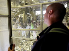 Covanta control room operator Vic Issighos moves garbage into a hopper, where it will be fed into a combustion chamber at the Vancouver Waste-To-Energy garbage facility where garbage shipped from the Philippines will be processed, in Burnaby.