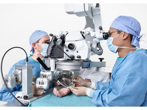 Surgeons using Microsure's MUSA during a microsurgical procedure in a patient's arm. Photo courtesy of Microsure.
