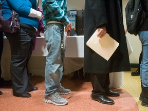Resumes in  hand, people line up at an Employment Ontario Job Fair. Despite record unemployment, job security is a big worry for Canadians.