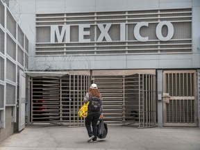 A woman walks towards Mexico from San Ysidro, California on May 31, 2019.