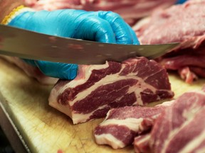 Canadian pork shoulders are prepped on a butcher's counter in Toronto, Ontario.