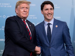 In this file photo taken on June 8, 2018, US President Donald Trump and Canadian Prime Minister Justin Trudeau hold a meeting on the sidelines of the G7 Summit in La Malbaie, Quebec, Canada.