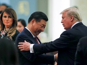 China's President Xi Jinping, U.S. President Donald Trump and first lady Melania attend a state dinner at the Great Hall of the People in Beijing on November 9, 2017.