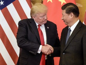 In this file photo taken on November 9, 2017, U.S. President Donald Trump shakes hand with China's President Xi Jinping in Beijing.