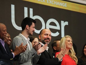 Uber CEO Dara Khosrowshahi (centre) joins other employees in ringing the Opening Bell at the New York Stock Exchange (NYSE) as the ride-hailing company Uber makes its highly anticipated initial public offering (IPO) on May 10, 2019 in New York City.