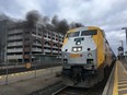 A smoking Via Rail engine is shown as it idles at the Oakville, Ont. train station on March 22, 2019.