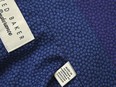 A “Made in Vietnam” label on a shirt manufactured in Vietnam. Some importers had been illegally re-packing goods from China in "Made in Vietnam" packaging and then applying for a Vietnamese certificate of origin with which to export to the United States, Europe and Japan, Vietnam customs said.