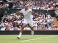 Roger Federer returns a shot at the 2019 Wimbledon Championships to Lloyd Harris of South Africa.